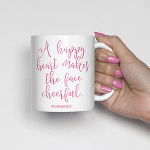 A happy heart makes the face cheerful. Proverbs 15:13, bible scripture, watercolor, calligraphy mug

